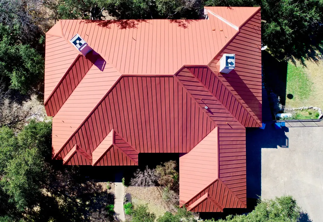 Metal roof installation on a residential home by Apache Roofing & Construction