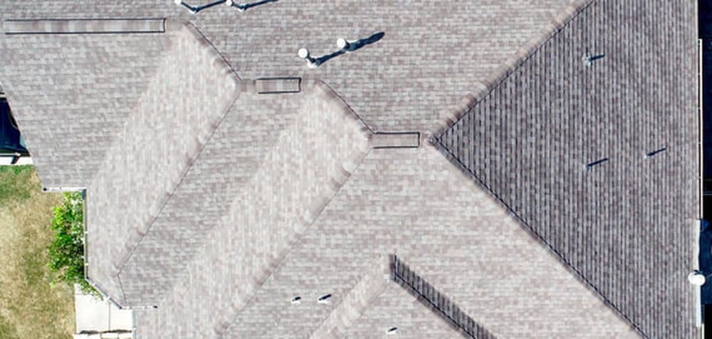 Aerial view of an architectural shingle roof on a suburban home